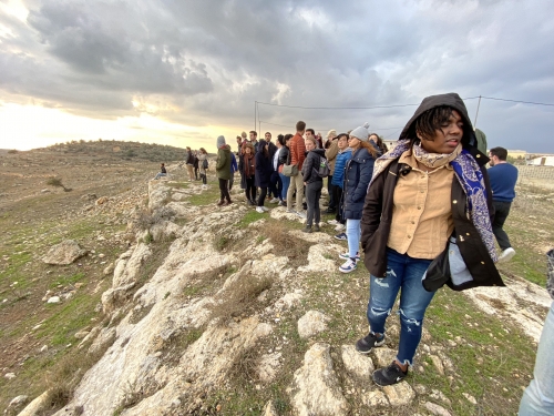 Group of tourists overlooking a village from a distance